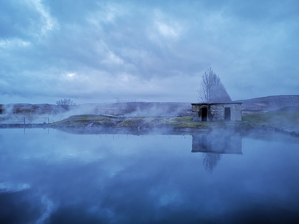 Steam rising off the Secret Lagoon (Gamla laugin) in Flúðir, a quiet hot spring just off the Golden Circle