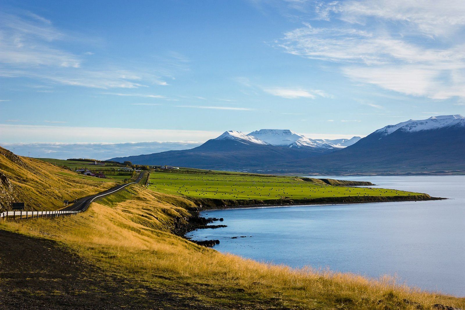 The Ring Road running past a fjord and snow-capped mountains in north Iceland